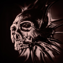 The terrible skull breaks through the plane. Can be used to create cards for Halloween.