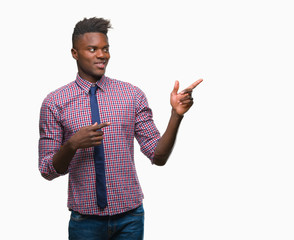 Young african american business man over isolated background smiling and looking at the camera pointing with two hands and fingers to the side.