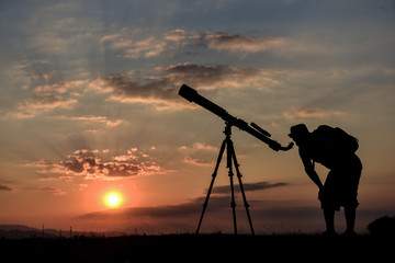 student studying with telescope