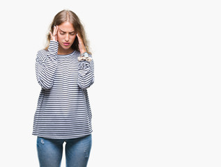 Beautiful young blonde woman wearing stripes sweater over isolated background with hand on head for pain in head because stress. Suffering migraine.