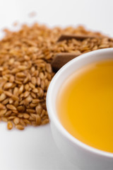 Seeds of golden flax on a white background