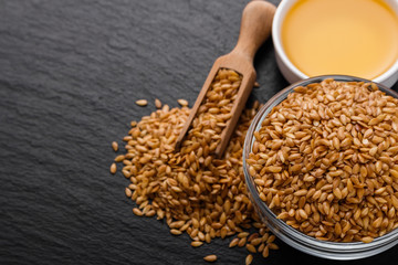 seeds of golden flax on a dark stone background