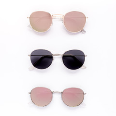 Female sunglasses on white background. Flat lay, top view. 