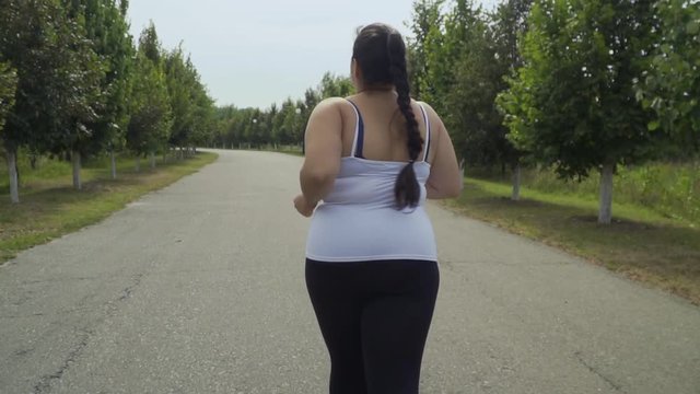 Fat girl runs along the road