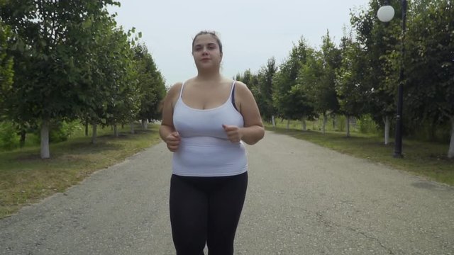 Fat girl runs along the road