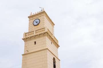 Old clock beige tower in the sky
