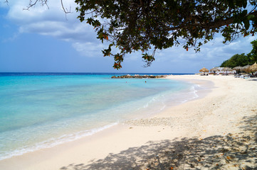 Hidden beach with white sand and blue water in Curacao