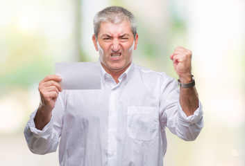 Handsome senior man holding blank card over isolated background annoyed and frustrated shouting with anger, crazy and yelling with raised hand, anger concept