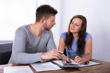 Young Couple Calculating Invoice