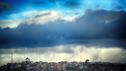 clouds over city quito ecuador with plain