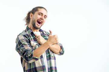 Happy young man lifted his thumbs up. Emotions and gesture: cheerful, joy, very good, excellent,...