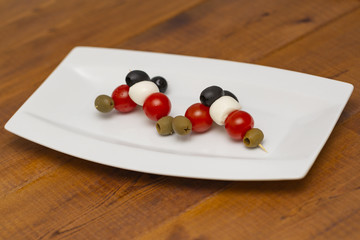 Italian appetizer, olives with mozzarella and tomatoes