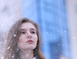 Young girl outdoors in winter. Model girl posing outdoors on a w