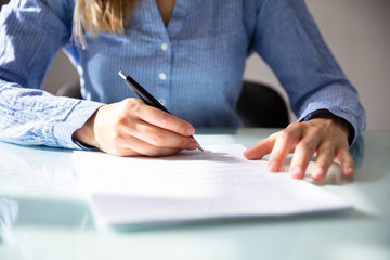 Businesswoman's Hand Signing Contract