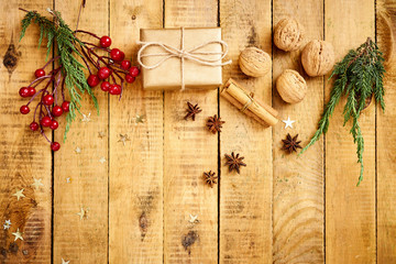 beautiful Christmas Eve background on an old wooden table with gifts and nuts decorations