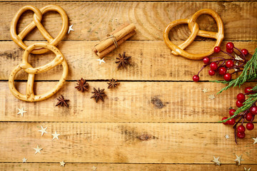 beautiful Christmas Eve background on an old wooden table with decorations and delicious pretzels