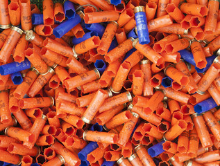 Background of many colorful shot empty shotgun shells