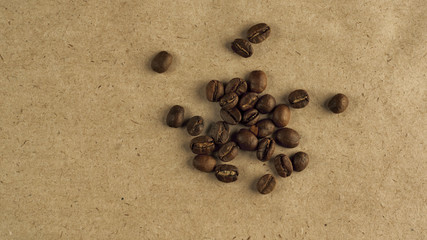 Fototapeta na wymiar Beans of natural coffee on coarse paper