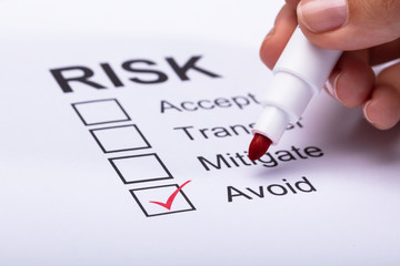 Woman Ticking Avoid Option On Risk Form