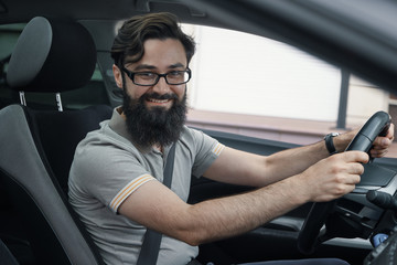 Happy car driver with fastened seat belt