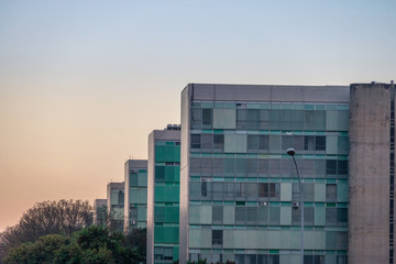Ministry buildings at Esplanade of the Ministeries (Esplanada dos Ministerios) at sunset - government departments offices - Brasilia, Distrito Federal, Brazil - obrazy, fototapety, plakaty