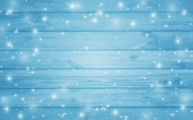 Blue snow-covered wooden background. Winter. Snowstorm. Snowfall. Christmas wood background. Night and snowflakes on the background of boards.