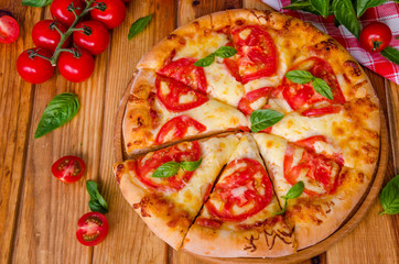 traditional Italian pizza margarita with tomatoes and mozzarella cheese
