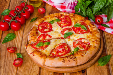 traditional Italian pizza margarita with tomatoes and mozzarella cheese