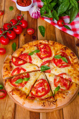 traditional Italian pizza margarita with tomatoes and mozzarella cheese