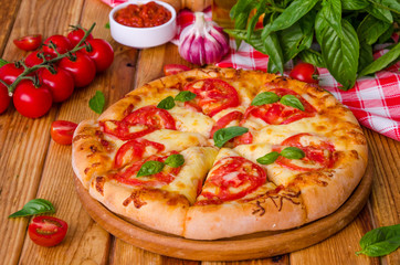 traditional Italian pizza margarita with tomatoes and mozzarella cheese