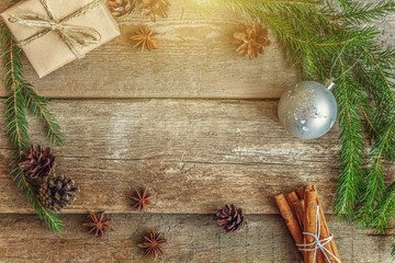 Christmas New Year composition with gift box fir branch pine cones cinnamon sticks on old shabby rustic wooden background. Xmas holiday december decoration to Russian tradition. Flat lay, copy space