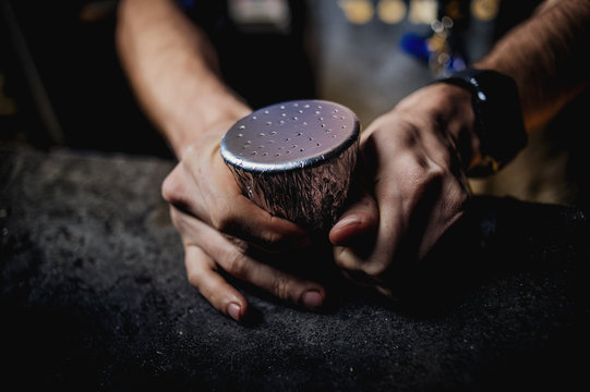 a man is hammering a hookah