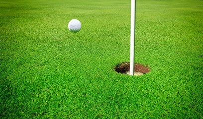 A golf ball at the hole