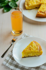 Slice of apple - curd cake with a glass of apple juice