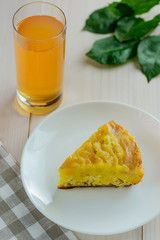 Slice of apple - curd cake with a glass of apple juice