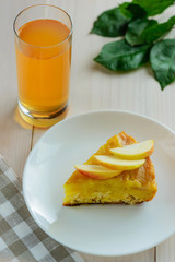 Slice of apple - curd cake with a glass of apple juice