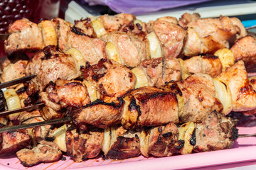 Shish kebab on skewers close-up. Pork shashlik cooked on grill