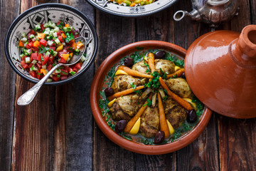 Slow cooked chicken with carrots, morrocan tajine, rustic style