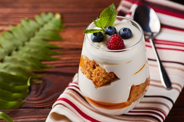 Glass with mascarpone, biscuits, berries dessert