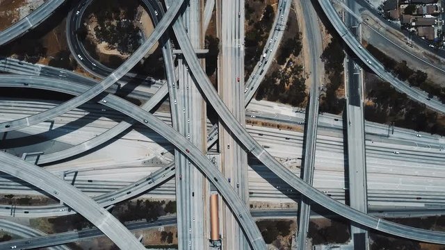 Drone zooming in on amazing Judge Pregerson junction interchange with cars moving through multiple level road flyovers.