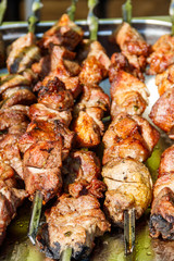 Shish kebab on skewers close-up. Pork shashlik cooked on grill