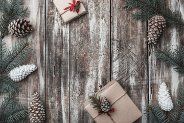 Old wooden background. Fir branches, cones. Space for Santa's message. Gifts. Holiday card. Modern and original gifts. Xmas and Happy New Year composition. Flat lay, top view