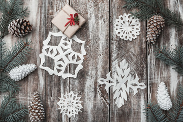 Old wooden. Fir branches, cones. Christmas Fellowship, New Year and Xmas. Space for Santa's message. Gift. Holiday card. Decorative snowflakes. Xmas and Happy New Year composition. Flat lay, top view