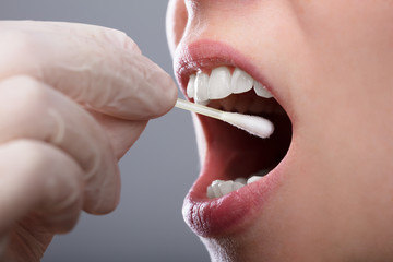 Woman Taking Saliva Test From Her Mouth - obrazy, fototapety, plakaty