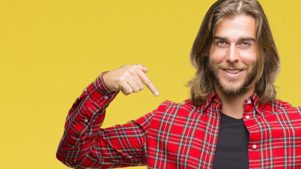 Young handsome man with long hair over isolated background looking confident with smile on face,...