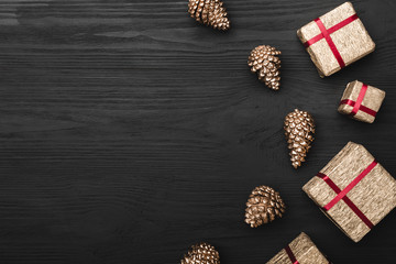 Upper, top view, of Christmas presents on a wooden black rustic background, with space for text...