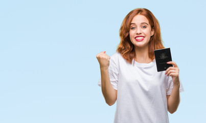 Fototapeta premium Young beautiful woman holding passport of australia over isolated background screaming proud and celebrating victory and success very excited, cheering emotion