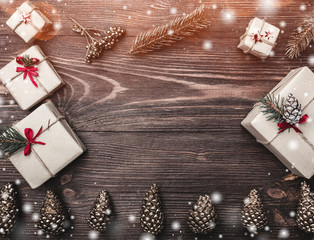 Brown wood background with fir cones, handmade gifts with greeting card space for winter, xmas, New...