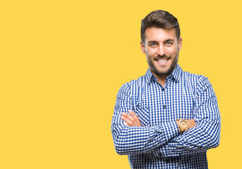 Young handsome man over isolated background happy face smiling with crossed arms looking at the camera. Positive person.