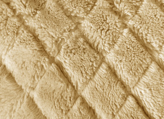 Fabric beige in artificial fur with a short pile used for clothing and furniture and covered with a diamond